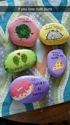 four rocks with different designs and words on them