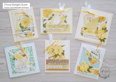 four cards with yellow flowers on them and some ribbon tied around the edges, sitting on a wooden surface