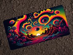 a laptop cover with an image of the sun rising over mountains and waves on it