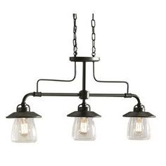 three light chandelier with clear glass shades on the bottom and black metal arms