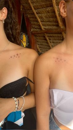 two women with small stars on their chests