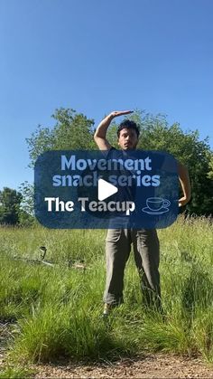 a man holding up a sign that says movement snackers the teacup on it