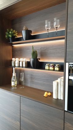 the shelves in this kitchen are filled with wine glasses and other items that include candles