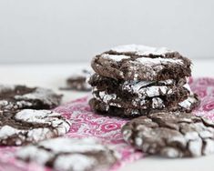 chocolate crinkle cookies with powdered sugar on pink and white table cloths