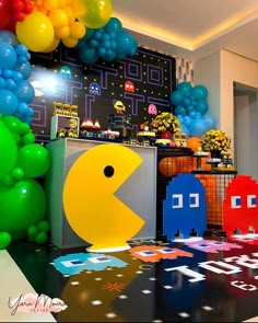 the pacman birthday party is decorated with balloons, streamers, and other decorations