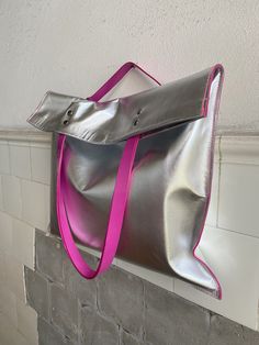 High quality Silver Metallic Leather Tote with Pink Leather Shoulder Strap made of leather from Italy.  Long Pink Handles to fit comfortably over your shoulder. The top fastens gently with Magnets, keeping your valuables secure. While the Smaller Internal Leather Pocket, keeping you organized your small stuff and Items. This Silver Metallic leather has a smooth surface and is tough and durable, leather soft, pleasant to the touch and slightly stretchy. This is a handmade Silver Pink Leather Tote Silver Leather Bags With Leather Handles, Silver Bag With Snap Closure For Everyday, Silver Leather Bag With Snap Closure, Silver Bags With Snap Closure For Everyday Use, Silver Bags With Snap Closure, Silver Leather Shoulder Bag As Gift, Silver Leather Shoulder Bag For Gift, Pink Handles, Small Stuff