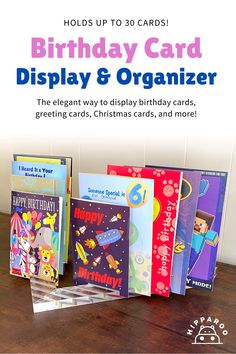 the birthday card display and organizer is displayed on a wooden table with colorful greeting cards