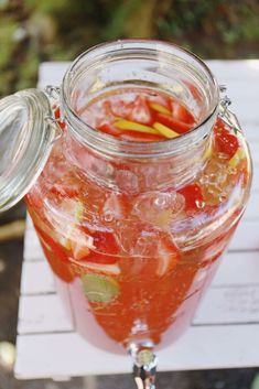 a glass jar filled with liquid sitting on top of a table