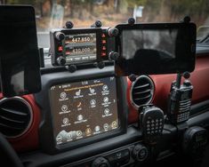 the dashboard of a car with two different electronic devices on it's display screen