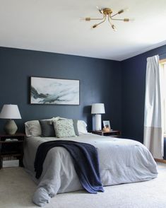 a bedroom with blue walls and white carpet