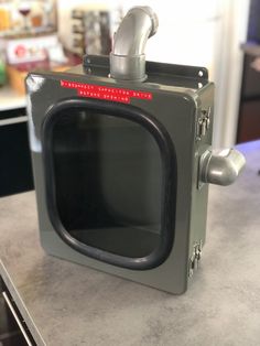 an old fashioned television sitting on top of a counter