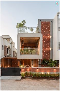 an apartment building with plants growing on the balconies