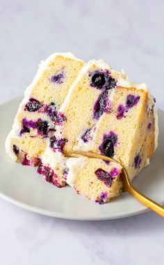 a piece of cake with blueberries and cream cheese frosting