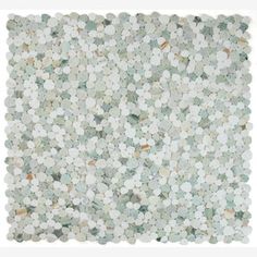 a white and green mosaic tile with small circles on the bottom, surrounded by smaller dots