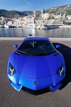 a blue sports car is parked in front of the water with words that read,'an investment in knowledge pays '