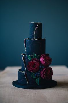 a three tiered cake with flowers on it