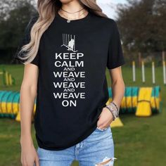 a woman wearing a black t - shirt that says keep calm and weave and we have weave on