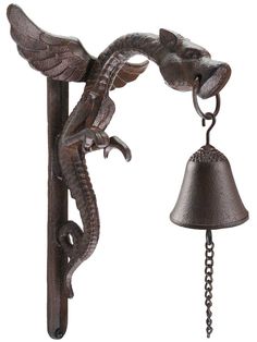 an ornate metal wall mounted bell and dragon figurine