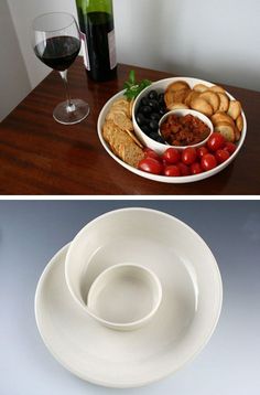 two plates with different types of food on them, one has grapes and the other has crackers