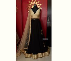 Made to Order/Measurement/Custom Order Lehenga - Color : Black and Gold - Fabric : Georgette - Fully flared black georgette full circle lehenga skirt with sequins gold border - Gold Embroidered Georgette plunge neckline blouse - Beige net dupatta with border and gold motifs - Drawstring closure with Tassels - Can can attached PLEASE NOTE: BUYERS ARE RESPONSIBLE FOR ANY CUSTOMS AND IMPORT TAXES THAT MAY APPLY. Fabric Care : Dry Clean Only Disclaimer: Please note the photographs are taken by mobil Black Lehenga, Georgette Lehenga, Lehenga Skirt, Gold Border, Net Dupatta, Gold Fabric, Pink Tulips, Gold Sequins, Indian Designer