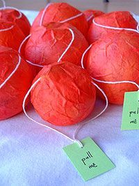 several red paper balls with tags attached to them