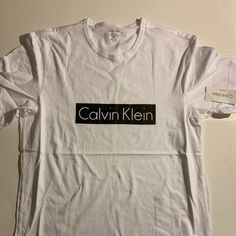 Short Sleeve Black Logo T-Shirt. Calvin Klein Cotton T-shirt With Graphic Print, Logo Cotton Tops With Relaxed Fit, Calvin Klein Crew Neck T-shirt For Streetwear, Cotton Logo Short Sleeve Tops, Calvin Klein Cotton Tops With Logo, Cotton Logo Top With Short Sleeves, Calvin Klein Logo Cotton Tops, Short Sleeve Cotton Top With Logo, Calvin Klein Cotton Logo Tops