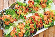 Shrimp, Sriracha, cilantro!? Yes please. 1 pound shrimp; 2 Tbs. Sriracha sauce; 4 cloves garlic, minced; 2 Tbs. extra-virgin olive oil; 1 head butter or boston lettuce, leaves separated; 1 red bell pepper, diced; 1 carrot, julienned; 3 scallions, thinly sliced; 1/4 cup cilantro; 1/4 cup soy sauce for drizzling; 1 pinch coarse salt and freshly ground pepper; 3 ounces thin rice noodles Shrimp Lettuce Cups, Asian Shrimp, Shrimp Lettuce Wraps, Fresh Appetizers, Blackened Shrimp, Grape Salad, Lettuce Cups, Spicy Shrimp, Lettuce Wraps