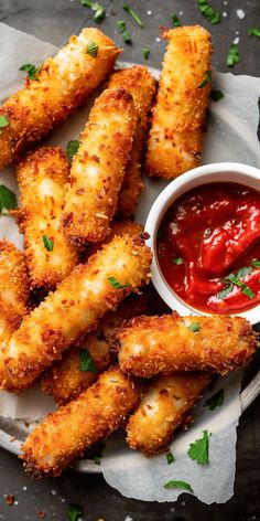 some fried food on a plate with ketchup and sauce