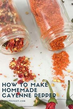 two glass jars filled with spices next to red peppers