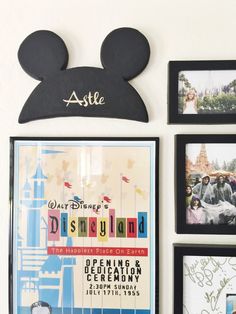 a mickey mouse head is mounted on the wall above some disney world posters and photos