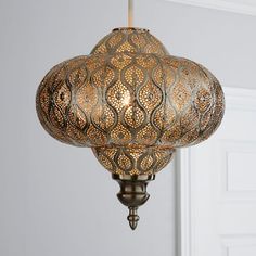 an ornate light fixture hanging from the ceiling in a room with white walls and doors