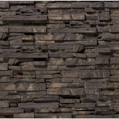 a stone wall that looks like it has been made out of rocks and is very dark brown