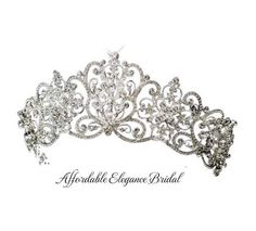 Regal Silver Plated Wedding or Quinceanera Tiara Crown This stunning bridal or quince tiara will add a regal touch to your wedding day. The intricately designed wedding crown features a striking silver plated floral scroll design decorated with brilliant crystal rhinestones. This gorgeous 2 1/2" high tiara with will be a fabulous headpiece for your royal inspired or classic wedding. End hoops make this piece easy to secure with bobby pins into any wedding hairstyle. Size: 17" Total Band Length, Silver Quince Crown, Silver Quince, Quinceanera Tiaras, Bridal Tiaras, Crystal Bridal Tiaras, Tiara Crown, Wedding Hairstyle, Fairy Tale Wedding, Wedding Crown