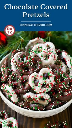 chocolate covered pretzels in a white bowl with sprinkles on top