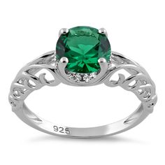 a ring with an emerald green stone in the center and diamond accents on the sides