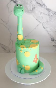 a green cake with a giraffe design on it