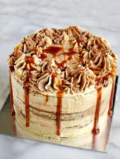 a cake with nuts and caramel drizzled on top