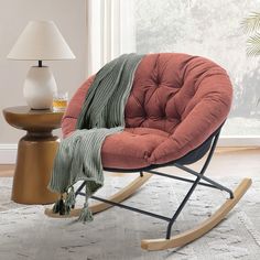 a rocking chair with a blanket on it