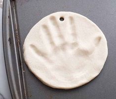 a hand print is on the bottom of a pizza pan