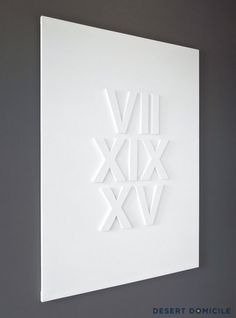 a white wall hanging on the side of a gray wall