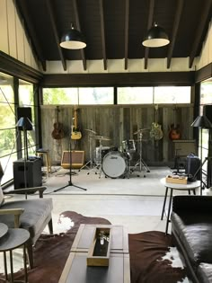 a living room filled with furniture and musical instruments