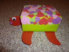 a paper box with hearts on it and a turtle made out of the inside of it