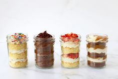 four jars filled with different types of desserts