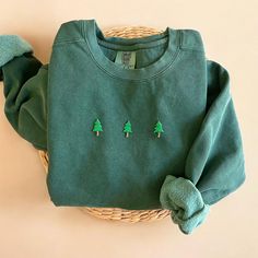 Cozy up with our Comfort Colors Christmas Trees Sweatshirt this winter season! The perfect gift for any Christmas Trees and Christmas season lovers out there! - Our sweatshirt material is super soft and high quality! ♡ - Garment-Dyed Sweatshirt (Sustainable style)  - 80% cotton, 20% polyester - All our sweatshirts run a UNISEX fit. (Both for men and women) They fit true to size. But if you like a more baggy look, we highly recommend sizing up. - These letters are embroidered iron-on patches that Vintage Christmas Sweatshirts, Matching Christmas Sweatshirts, Cozy Winter Holiday Sweatshirt, Casual Green Sweatshirt For Holidays, Casual Green Holiday Sweatshirt, Green Holiday Sweatshirt For Fall, Green Fall Holiday Sweatshirt, Cozy Christmas Sweater With Crew Neck, Cozy Christmas Crew Neck Sweater