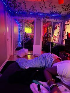 a person laying on a bed in a room with hello kitty wallpaper and lights