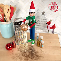 an elf is cooking on the counter with spices and utensils in front of him