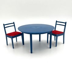 a blue table and two red chairs on a white background with one chair facing the other