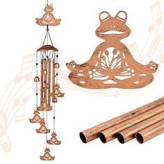 a wooden wind chime with musical notes on it and an image of a frog