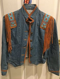 Small size but fits as S/M Denim western/ country style jacket.  Beaded with leather fringe Metal buttons. Festival Denim Jacket With Fringe And Long Sleeves, Fall Festival Denim Jacket With Fringe, Fall Festival Fringe Denim Jacket, Festival Denim Fringe Outerwear, Fringe Denim Jacket For Fall Festival, Bohemian Denim Jacket With Fringe For Fall, Western Style Denim Jacket For Rodeo, Western Style Denim Jacket For Rodeo In Fall, Medium Wash Outerwear For Rodeo In Fall