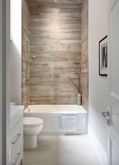 a bathroom with a toilet, bathtub and sink in it's center area